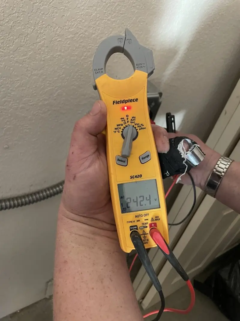 Voltage testing with clamp meter during Recessed Lighting Installation in Narberth